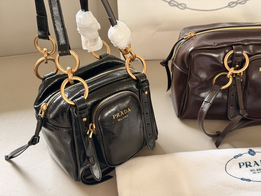 Prada Glossy Front-Pocket Top-Handle Bag — comparison