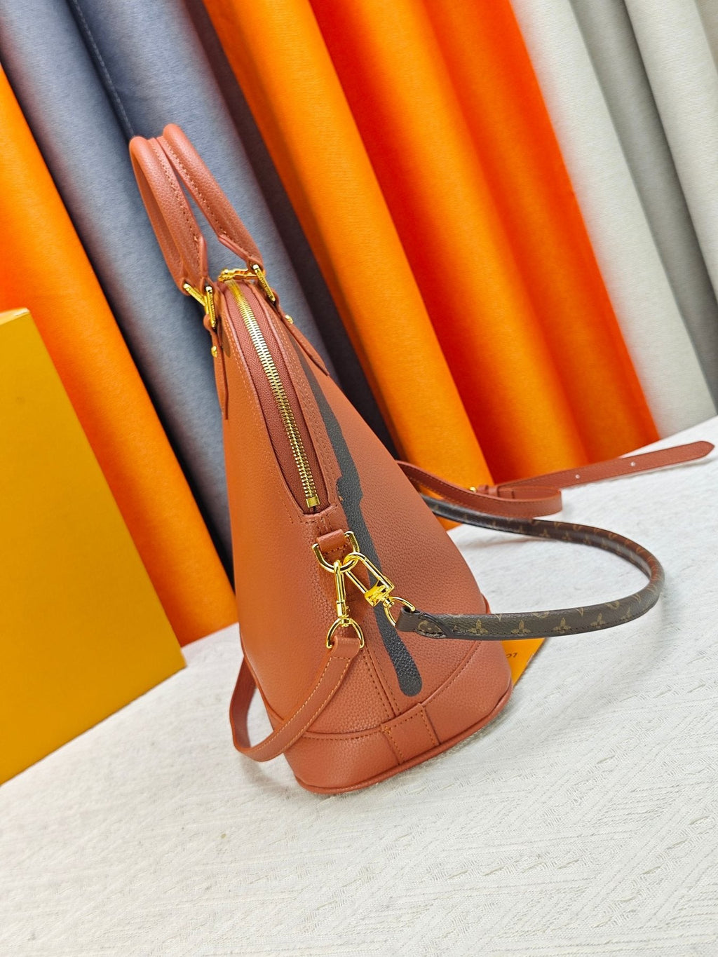 Louis Vuitton Alma Soft Cognac Top-Handle Bag — side